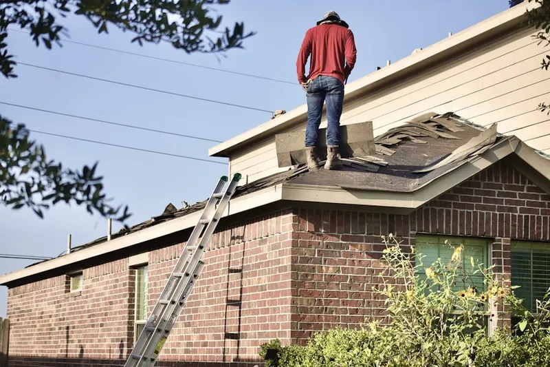 Professional roofer working on a residential roof in Oak Park